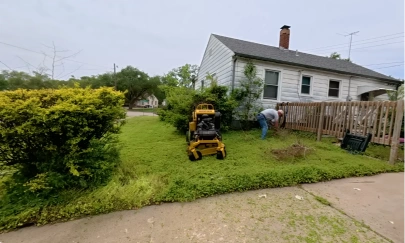 Zero-turn mower parked on a freshly mowed front lawn beside a house in Katy, TX